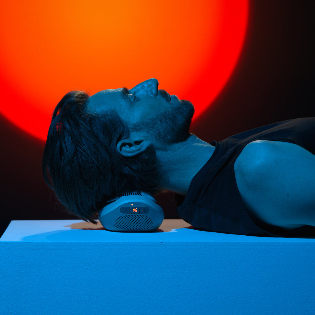 Man resting his neck on Contrast against a hot orange backdrop